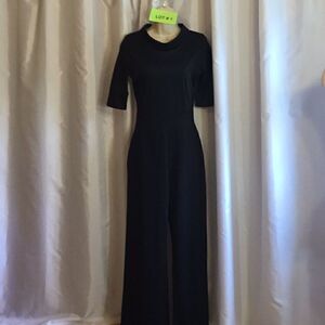 Black jumpsuit with 1/2 length sleeves in size small polyester blend material